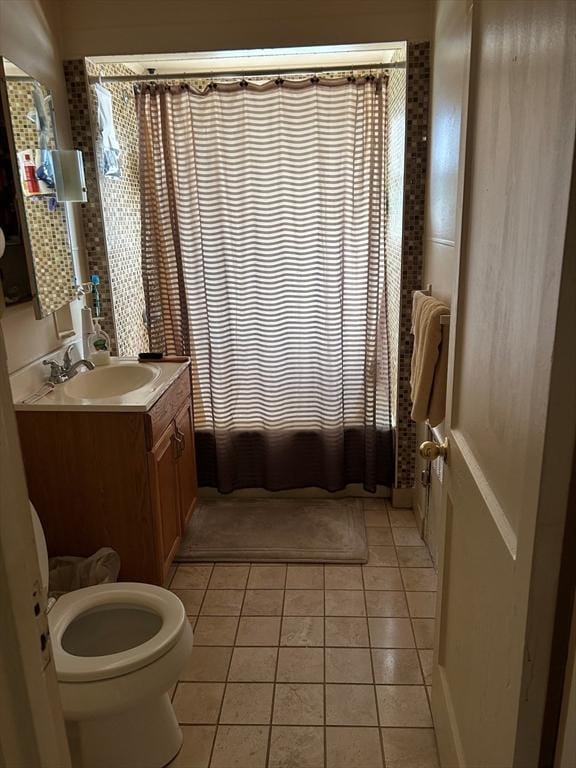 full bathroom featuring tile patterned flooring, shower / bath combo, vanity, and toilet