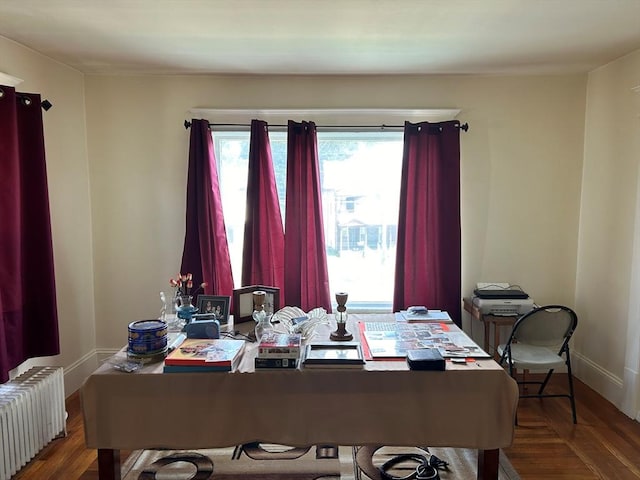 office space featuring radiator heating unit and hardwood / wood-style floors