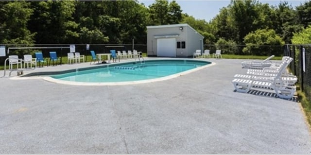 9 Lydon Ln Unit D2, Halifax, MA 02338 - community pool featuring a patio area and view of wooded area