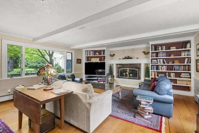104 Main St, Topsfield, MA 01983 - living area with beam ceiling, a glass covered fireplace, light wood-type flooring, built in features, and a baseboard radiator