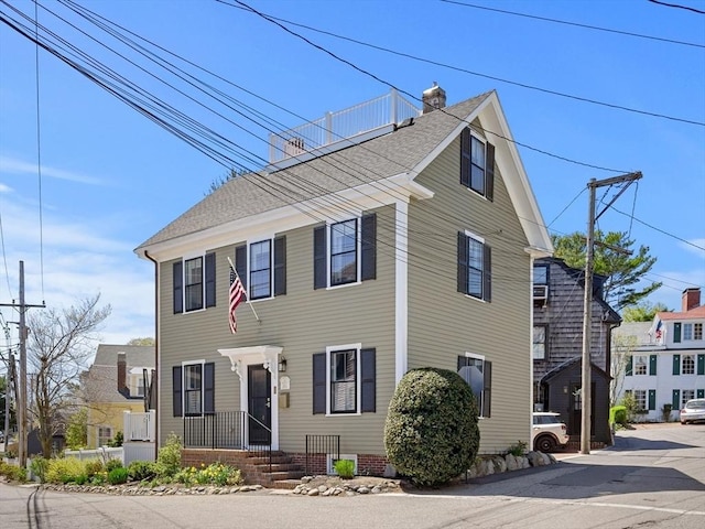 colonial-style house with a chimney