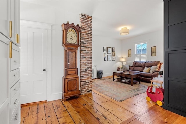 living room featuring light wood finished floors and baseboards