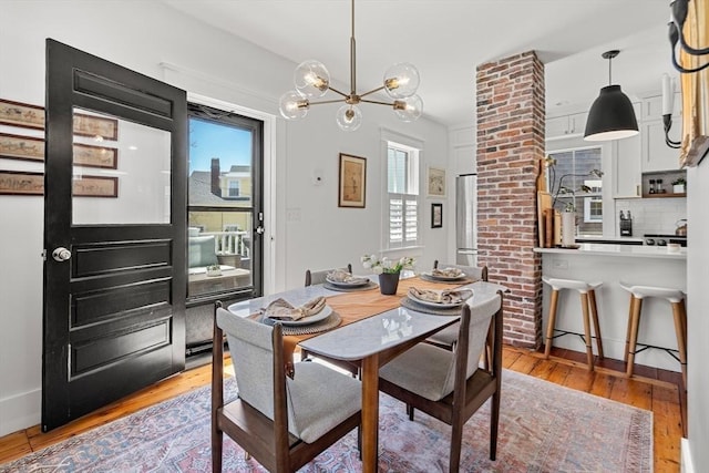 dining space with an inviting chandelier and light wood-style floors