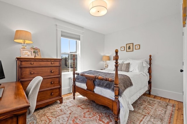 bedroom with light wood-style flooring and baseboards