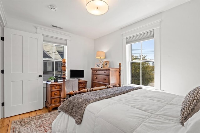 bedroom featuring light wood-style flooring and visible vents