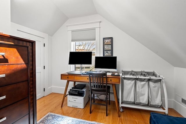 office area featuring vaulted ceiling, wood finished floors, and baseboards