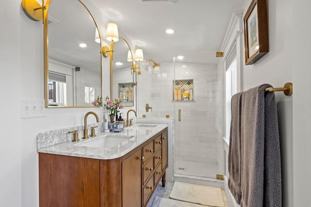 full bath with recessed lighting, double vanity, a stall shower, and a sink
