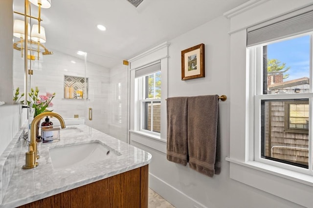 bathroom with a sink, lofted ceiling, visible vents, recessed lighting, and double vanity