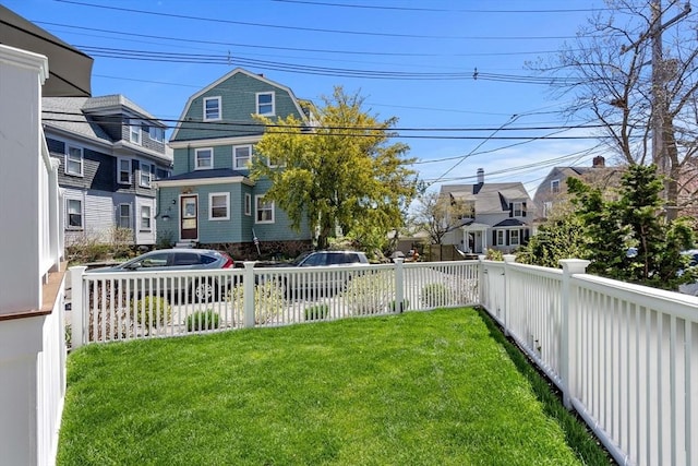 view of yard with fence and a residential view