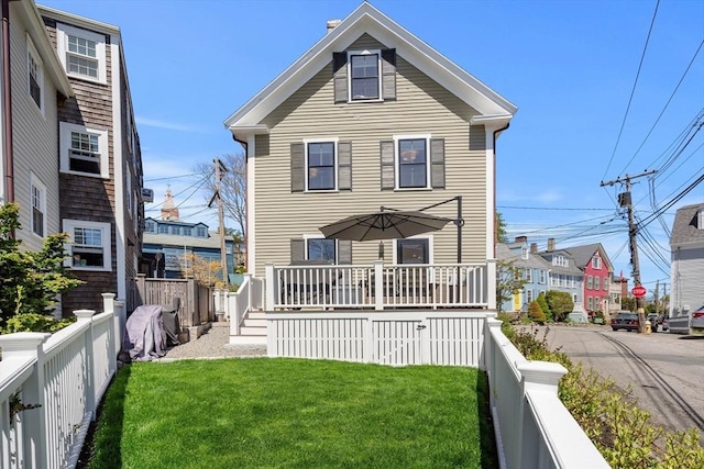 back of house with a yard, fence private yard, and a wooden deck