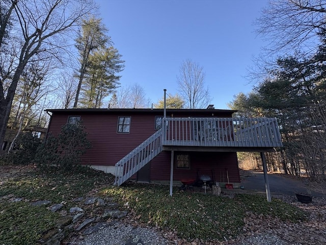 rear view of house featuring a deck