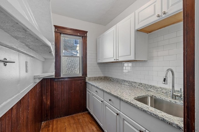 kitchen featuring white cabinetry, sink, and dark wood-type flooring