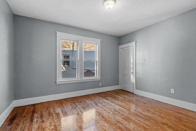 unfurnished room with hardwood / wood-style floors