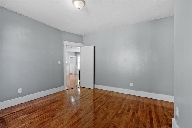 unfurnished room featuring hardwood / wood-style floors