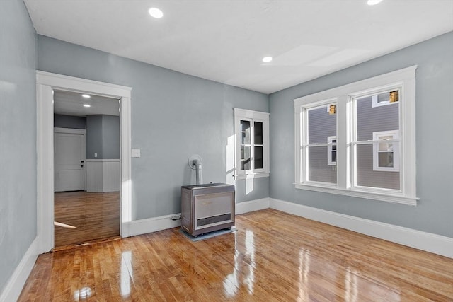 interior space featuring light hardwood / wood-style floors and a wood stove