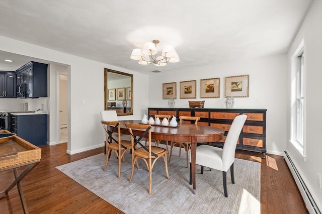 32 Iverson Rd, Beverly, MA 01915 - dining area with a baseboard heating unit, a chandelier, dark wood-type flooring, and baseboards