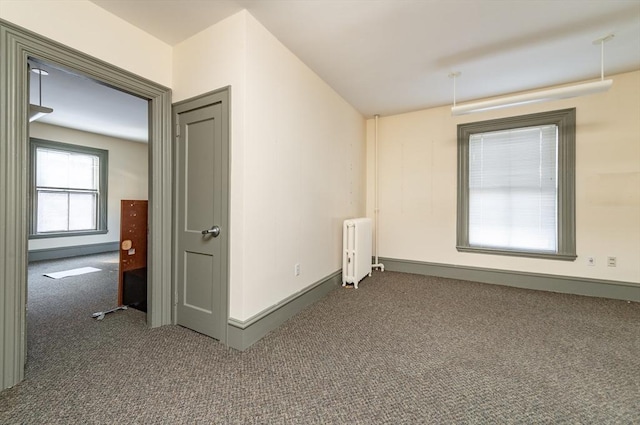 37 Mellen St, Cambridge, MA 02138 - carpeted spare room with radiator heating unit and baseboards