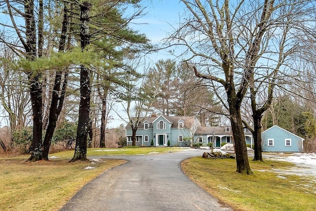 view of front of home with a front yard and driveway