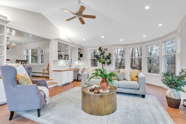 living area featuring a wealth of natural light, lofted ceiling, baseboard heating, and light tile patterned floors