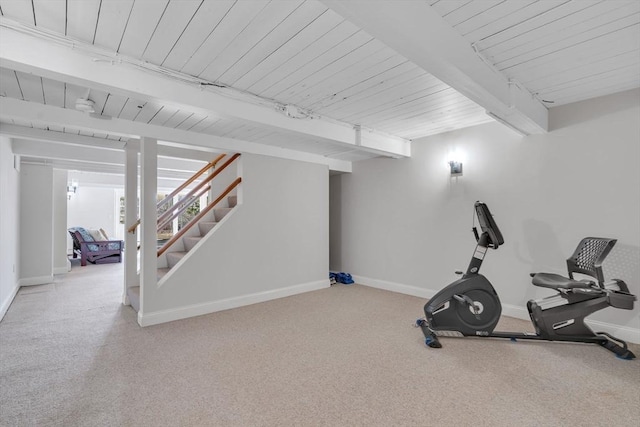 workout area featuring baseboards and carpet flooring