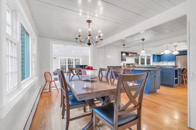 dining room featuring a baseboard heating unit, beam ceiling, light wood-style flooring, wooden ceiling, and an inviting chandelier