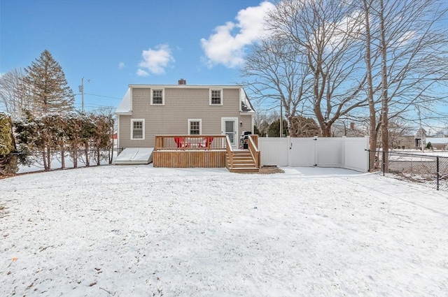 snow covered property featuring a deck