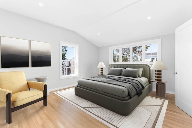 bedroom featuring vaulted ceiling and light hardwood / wood-style flooring