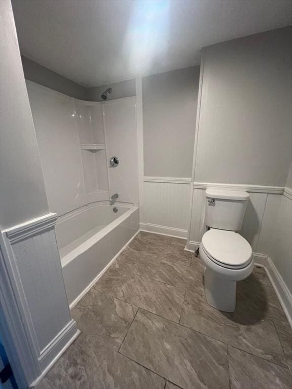 bathroom with bathtub / shower combination and toilet