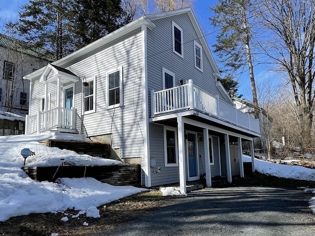 view of snow covered exterior with a balcony