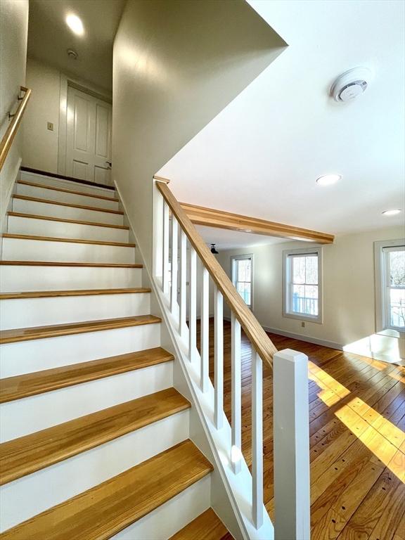 stairs with recessed lighting, baseboards, and hardwood / wood-style floors