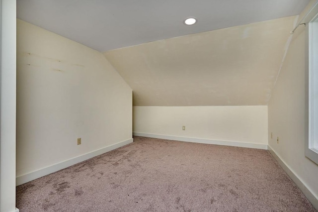 bonus room with baseboards, carpet flooring, and vaulted ceiling