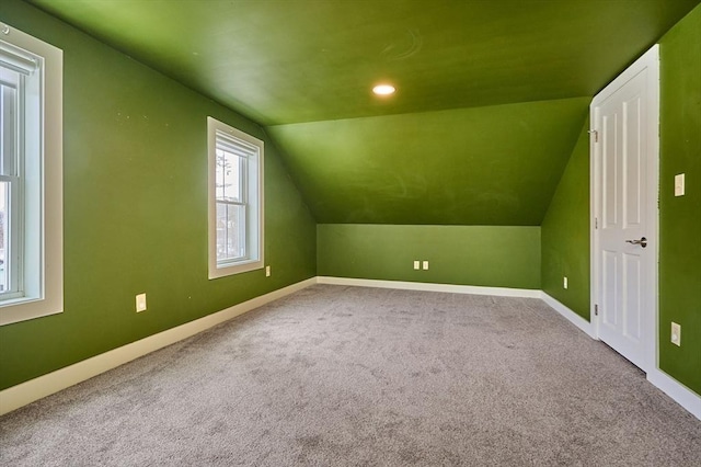 bonus room with baseboards, carpet, and vaulted ceiling