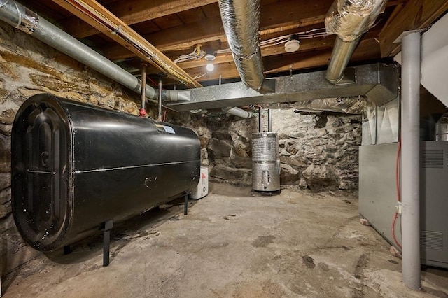 utility room with heating fuel and water heater