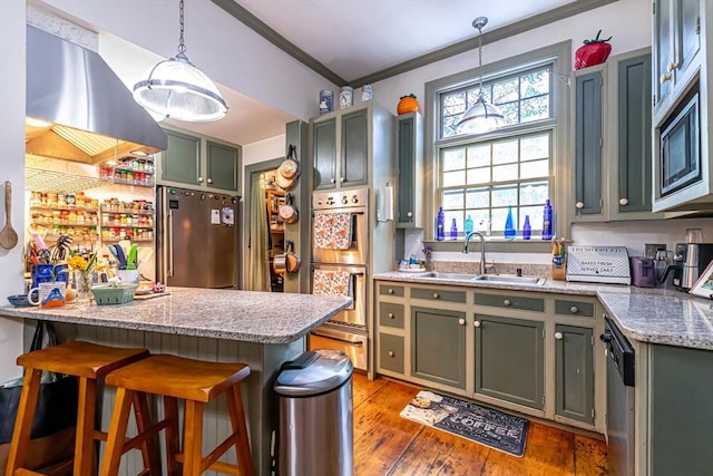 52 Central, Gardner, MA 01440 - kitchen featuring a sink, appliances with stainless steel finishes, crown molding, wall chimney range hood, and a kitchen breakfast bar