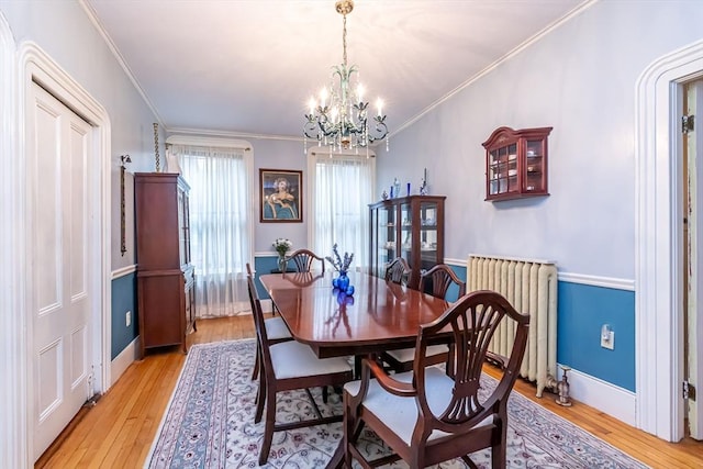 52 Central, Gardner, MA 01440 - dining room with radiator heating unit, a chandelier, light wood-type flooring, and crown molding