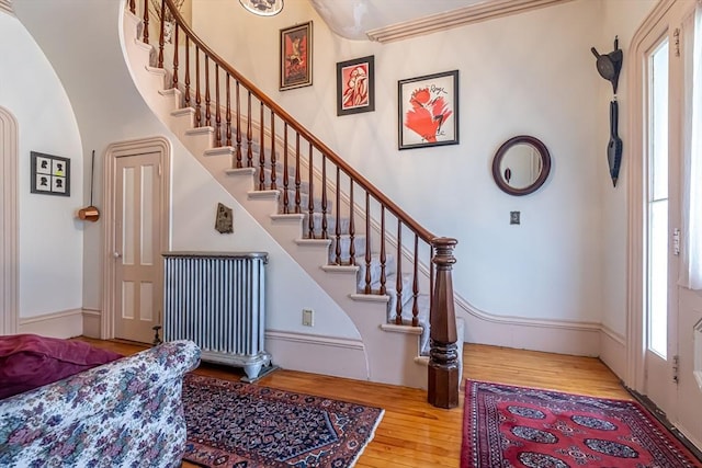 52 Central, Gardner, MA 01440 - stairway featuring wood finished floors, arched walkways, and radiator heating unit