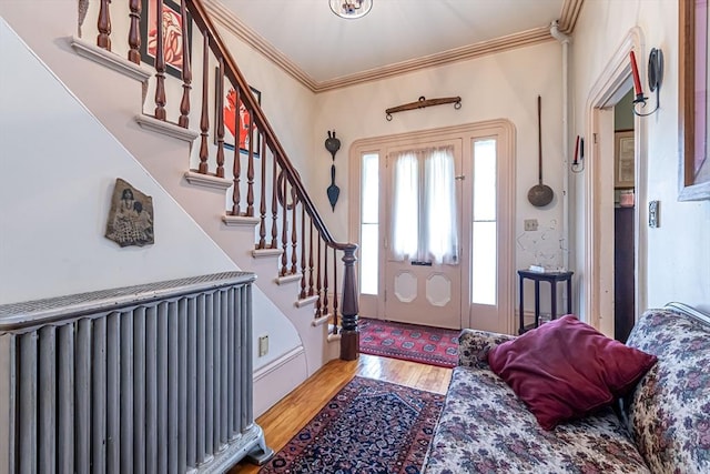 52 Central, Gardner, MA 01440 - foyer entrance with wood finished floors, ornamental molding, stairway, and radiator heating unit