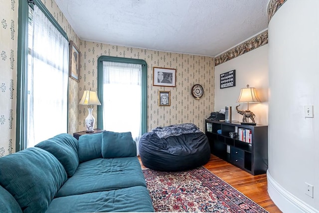 52 Central, Gardner, MA 01440 - living room with wallpapered walls, light wood-type flooring, a textured ceiling, and baseboards