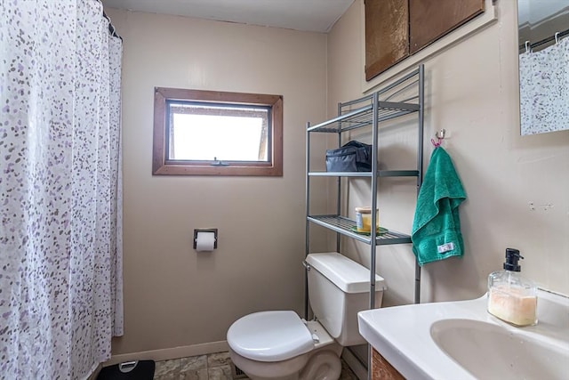 52 Central, Gardner, MA 01440 - bathroom featuring baseboards, toilet, vanity, and a shower with curtain
