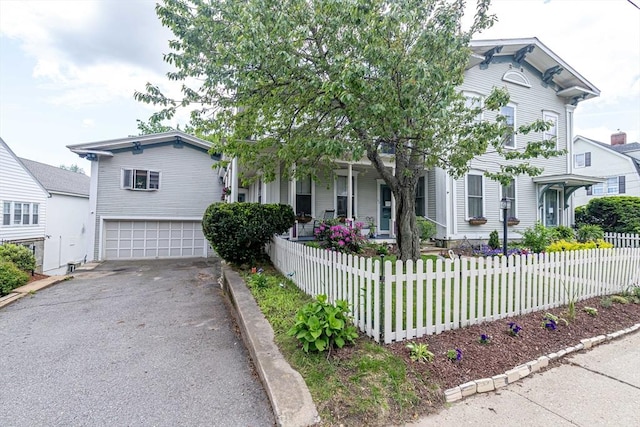 52 Central, Gardner, MA 01440 - view of front of home featuring driveway, an attached garage, a fenced front yard, and covered porch
