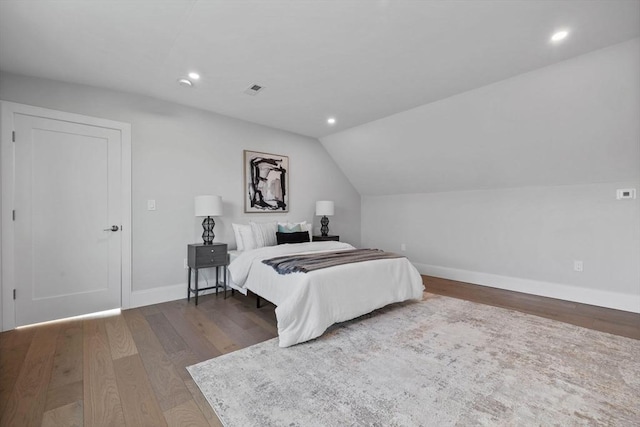 bedroom with lofted ceiling and dark wood-type flooring