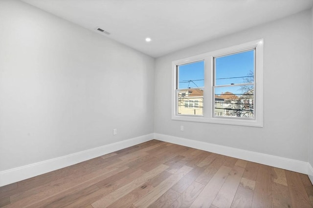 unfurnished room with light hardwood / wood-style flooring