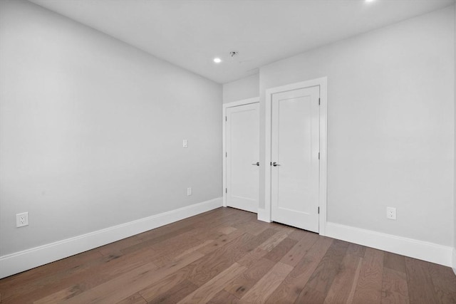 unfurnished bedroom with hardwood / wood-style flooring