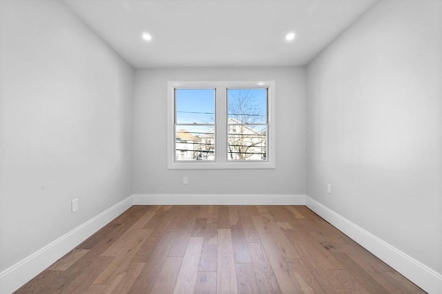 unfurnished room with wood-type flooring