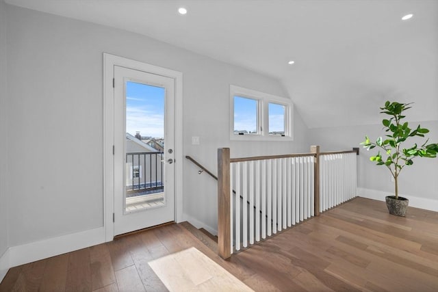 interior space with vaulted ceiling and light hardwood / wood-style flooring