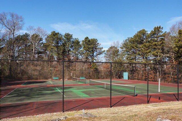 view of tennis court featuring fence