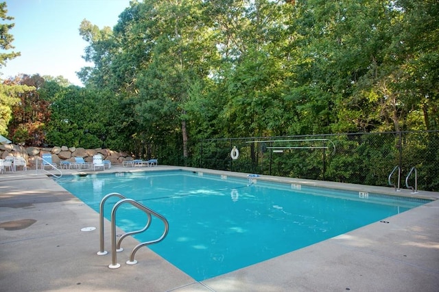 pool with fence and a patio