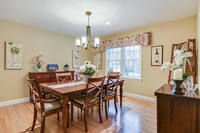 dining space with light wood-type flooring, baseboards, a chandelier, and recessed lighting