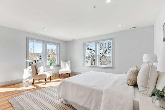 bedroom featuring light wood-type flooring, baseboards, and recessed lighting