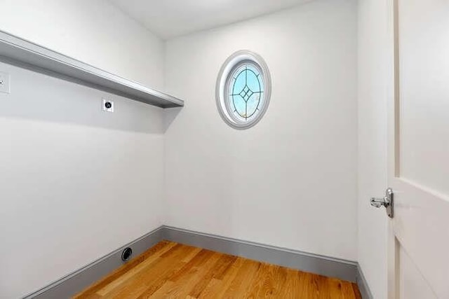 laundry area featuring laundry area and wood finished floors